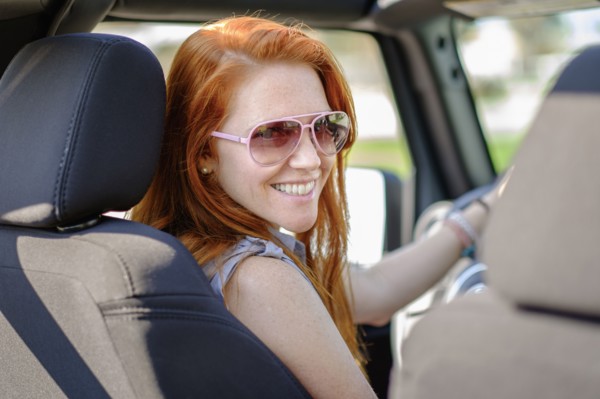 Portrait of woman sitting in car.