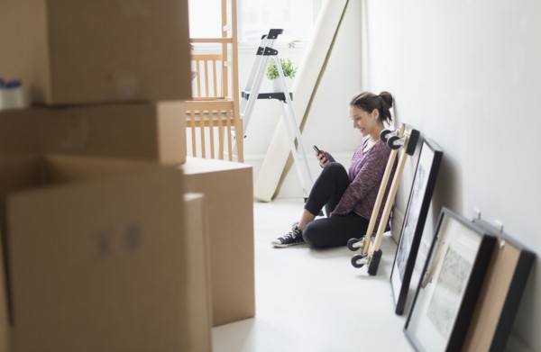 Young woman moving into new flat.