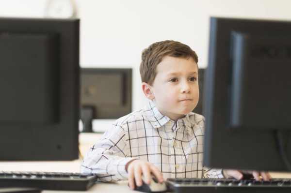 boy (6-7) using computer.