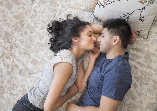 Young couple lying on bed.
