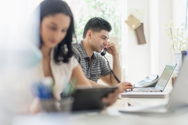 Young man and woman working in office.