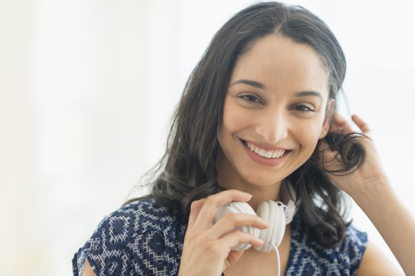 Portrait of smiling young woman with headphones.