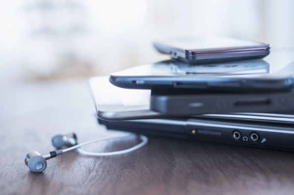 Close up of stack of devices on desk.