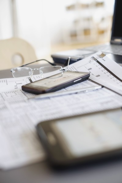 Close up of glasses on paperwork.