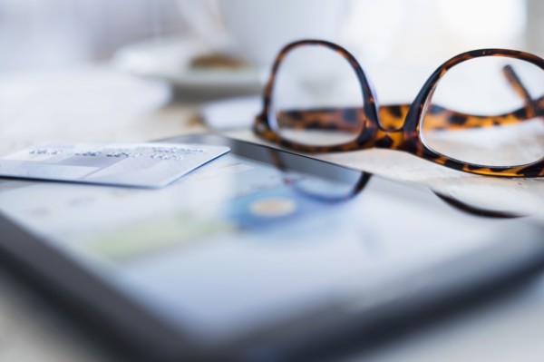 Close up of glasses and smartphone on table.