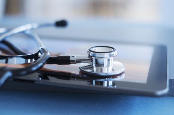 Close up view of stetoscope on digital tablet.