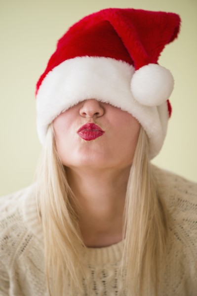 Studio Shot of woman wearing santa hat and puckering.
Photo : Jamie Grill
