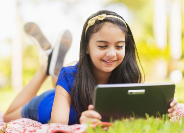 girl ( 8-9) using digital tablet .
Photo : Daniel Grill