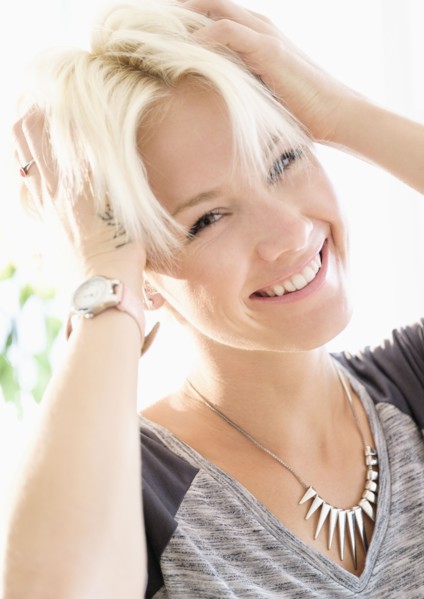 Portrait of blonde woman wearing necklace.