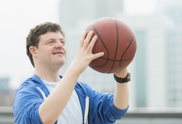 Man with down syndrome playing basketball.