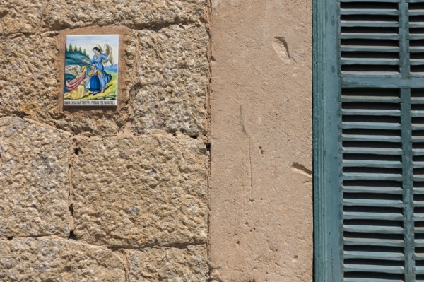 Close up of tile with angels on wall. Valldemossa, Mallorca, Spain.