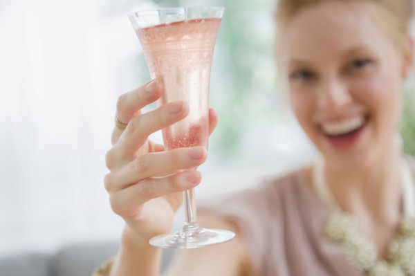Young woman toasting with champagne