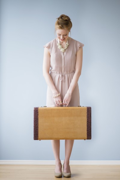 Young woman holding suitcase