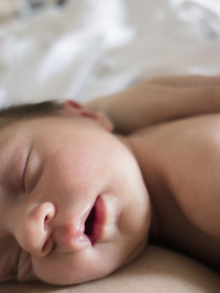 Mother holding newborn daughter