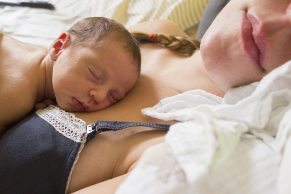 Mother holding newborn daughter
