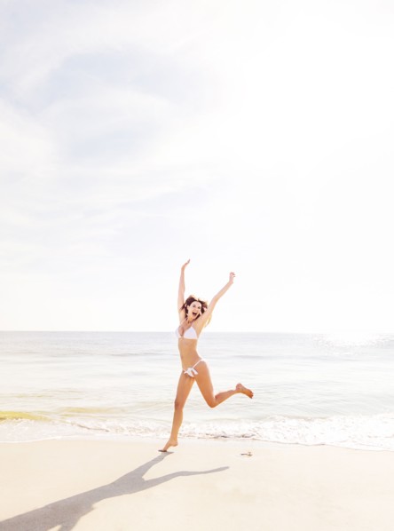 Woman jumping on beach