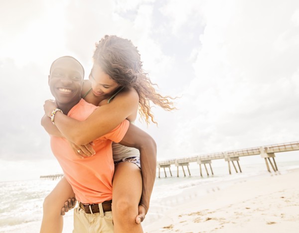 Young couple playing on beach