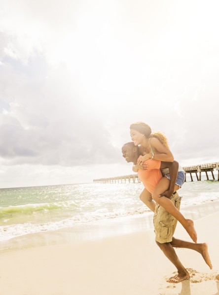 Young couple playing on beach