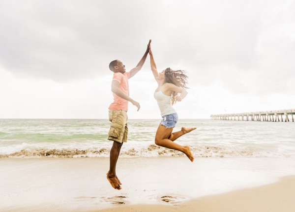 Young couple playing on beach