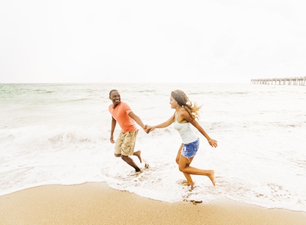 Young couple running on beach