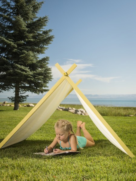 Girl (2-3) lying in tent