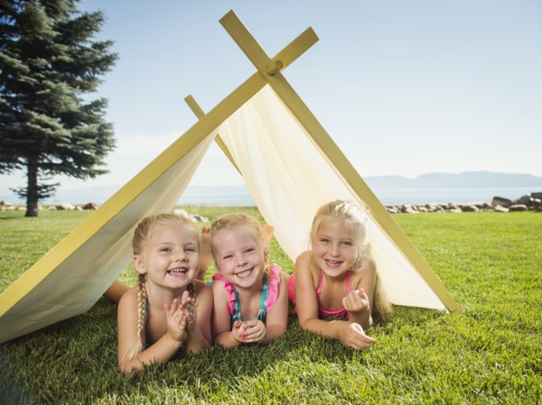 Three girls (2-3, 4-5) playing in tent