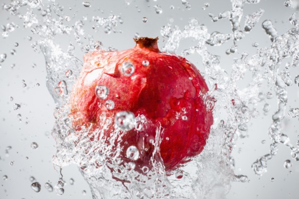 Droplets splashing on pomegranate