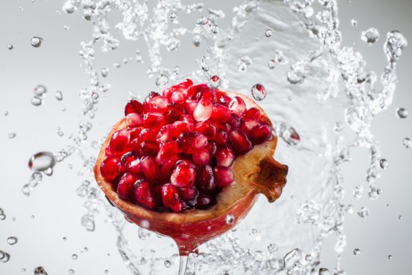 Droplets splashing on pomegranate