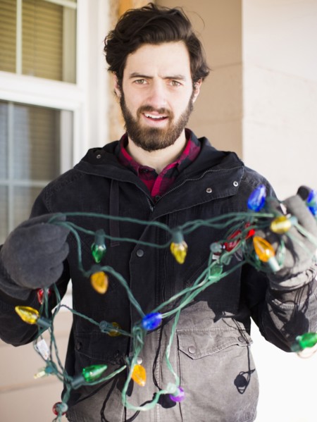 Front view portrait of young man with Christmas light