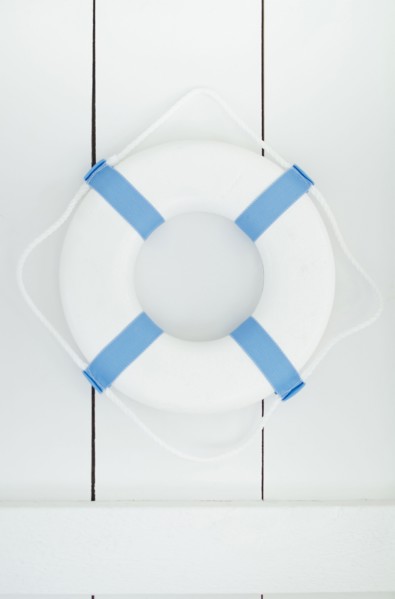 White lifebelt hanging on white wall