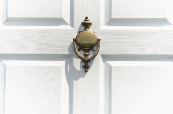 Close-up of white door with knocker