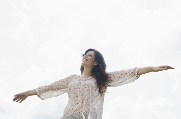 Happy woman against sky