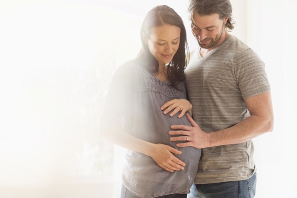 Happy man and his pregnant woman.