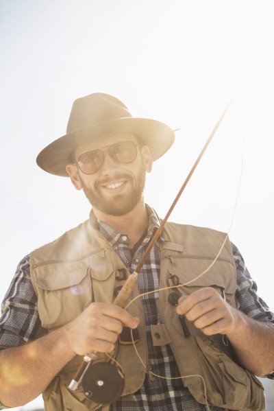 Portrait of man holding fishing rod.