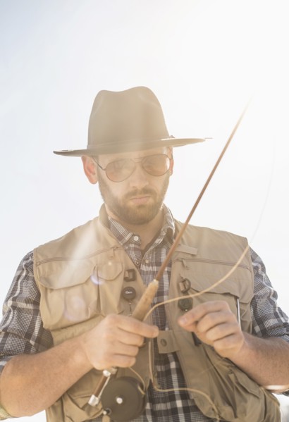 Portrait of man holding fishing rod.
