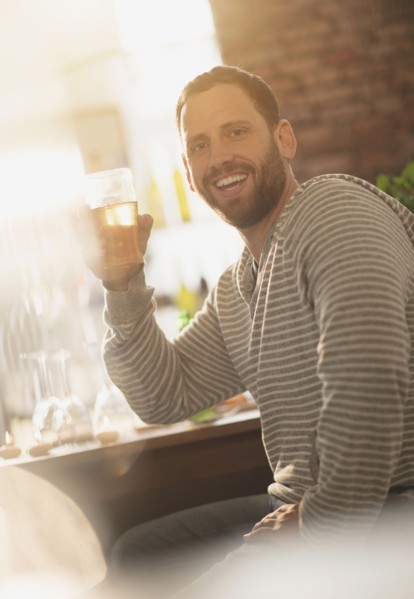 Portrait of man having drink in bar.