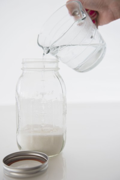 Woman mixing milk with water