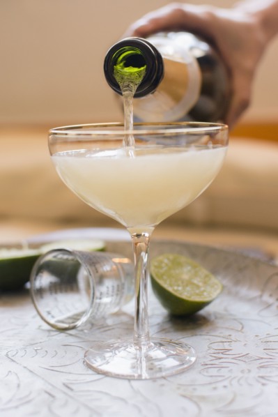 Woman mixing champagne with cocktail