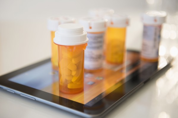 Pill containers on digital tablet