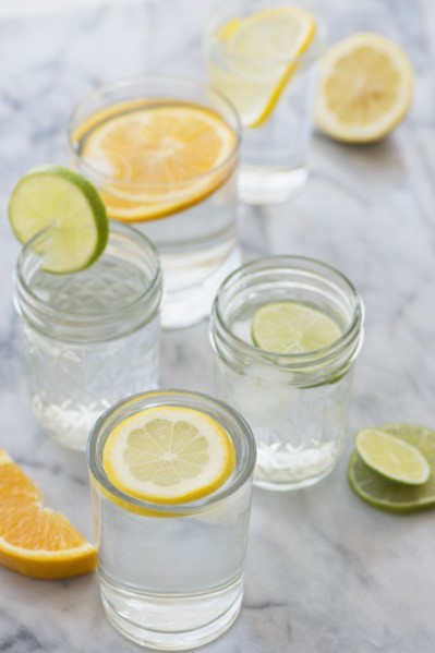 Studio shot of lemon, orange and lime drinks
