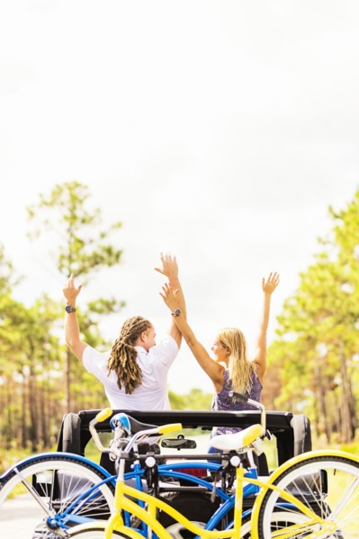 Couple rising hands in car