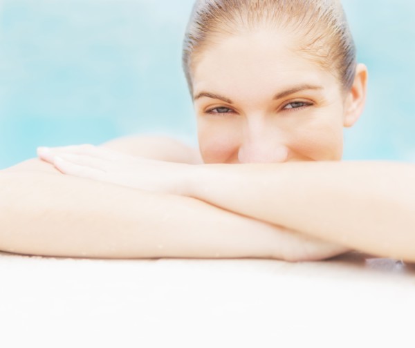 Portrait of woman on edge of swimming pool