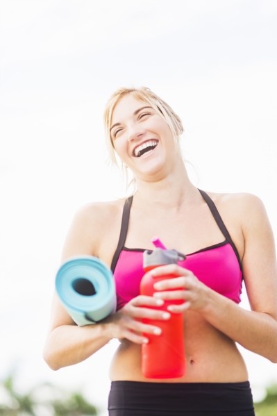 Portrait of smiling woman drinking water