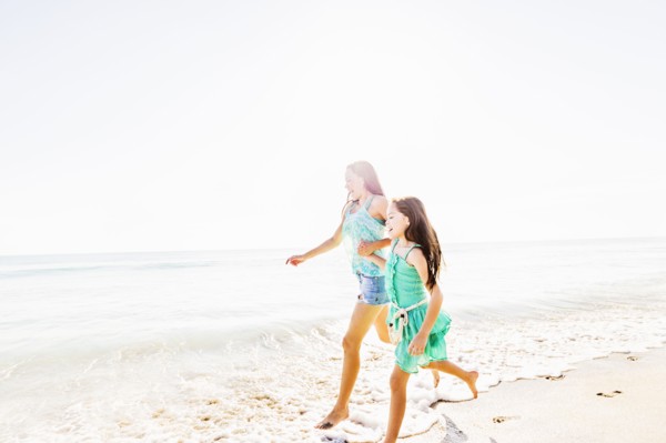 Mom and daughter (6-7) spending time together on beach