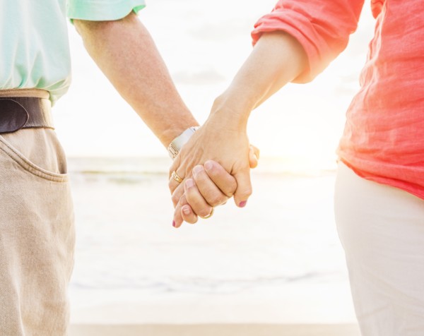 Couple holding hands on beach