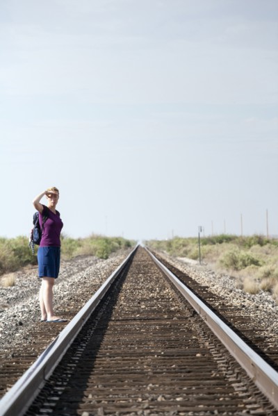 Woman standing by railroad track