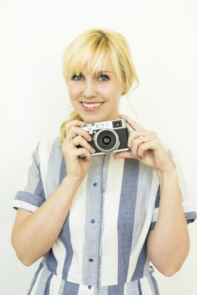 Studio shot of woman holding camera
