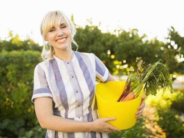Woman picking vegetables in garden