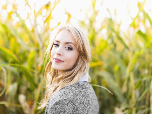 Portrait of young woman in corn field