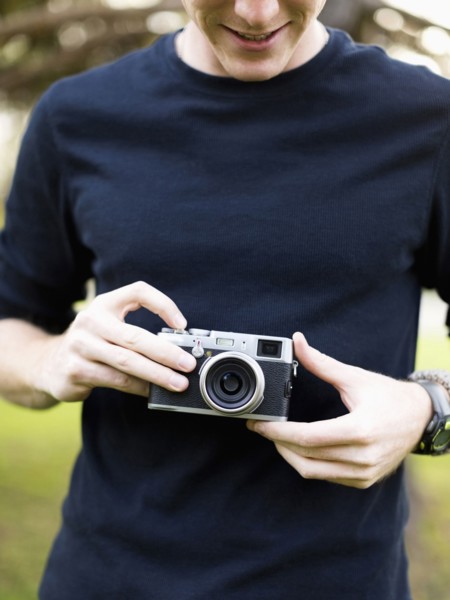 Young man holding camera